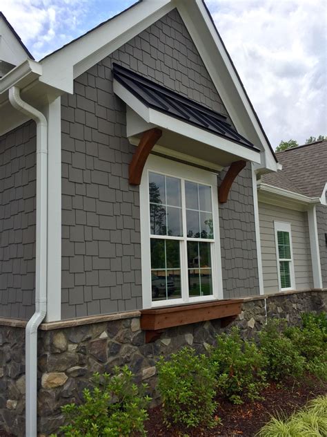 grey house with black awnings